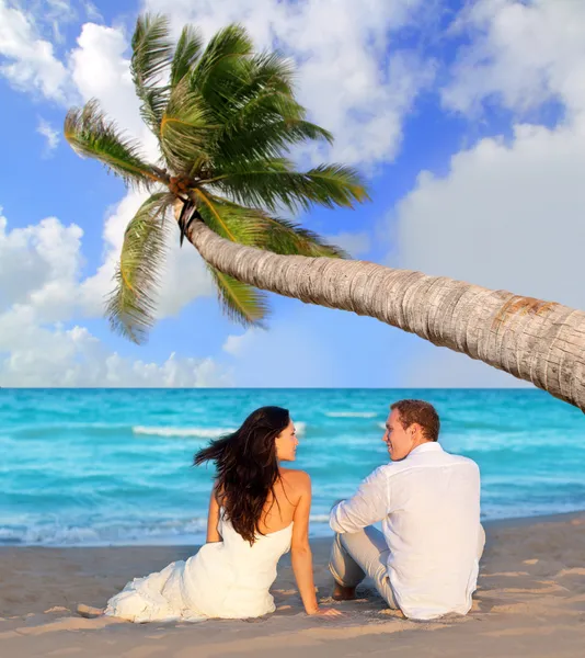 Couple in love sitting in blue beach Stock Image
