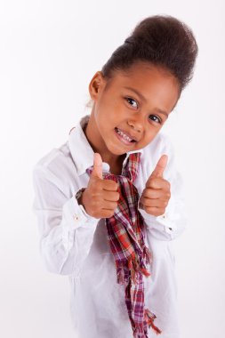 Cute little African Asian girl making thumbs up clipart