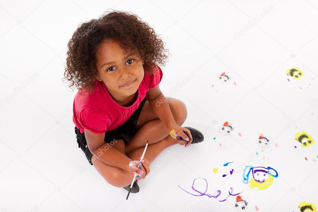 Little African Asian girl painting on the floor