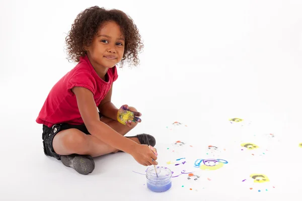 Little African Asian girl painting on the floor — Stock Photo, Image