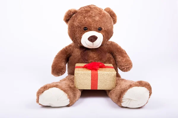 Seated teddy bear with gift boxes — Stock Photo, Image