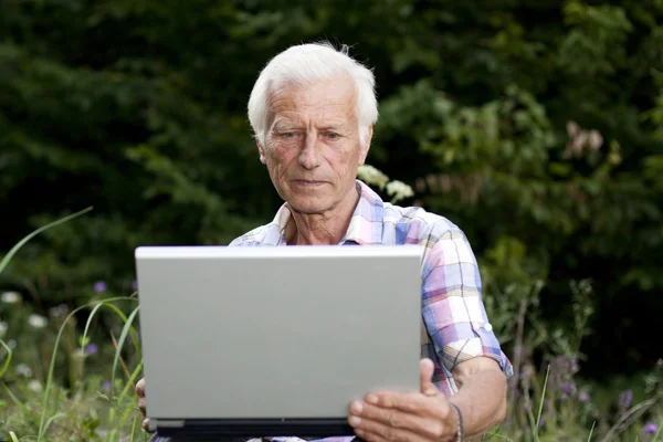 stock image An elderly man with a laptop