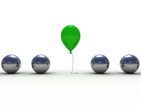 Zelený balón mezi lesklé kovové koule — Stock fotografie