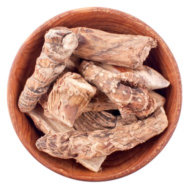 Dry calamus root in a wooden bowl isolated on white clipart