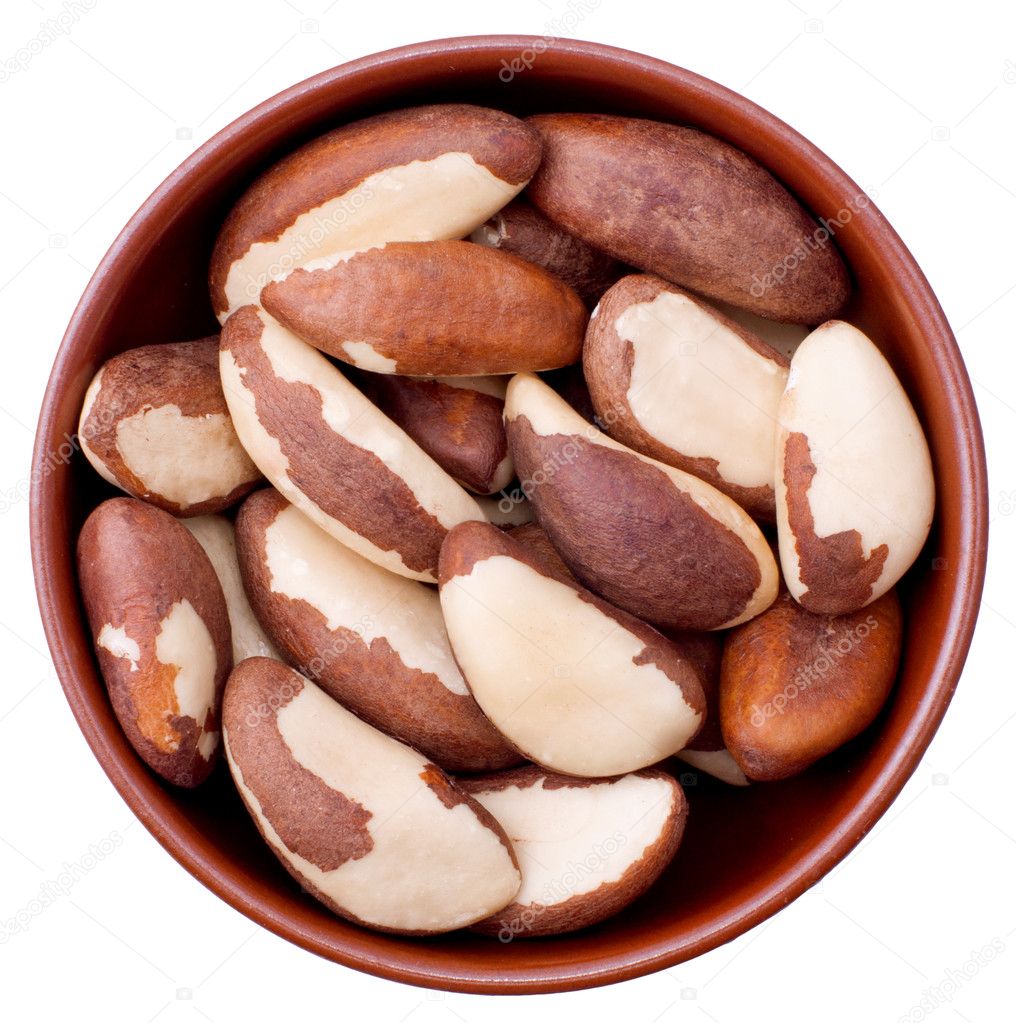 Ceramic bowl full of Brazil nuts isolated on white