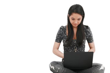 Beautiful young female student sitting on floor studying clipart