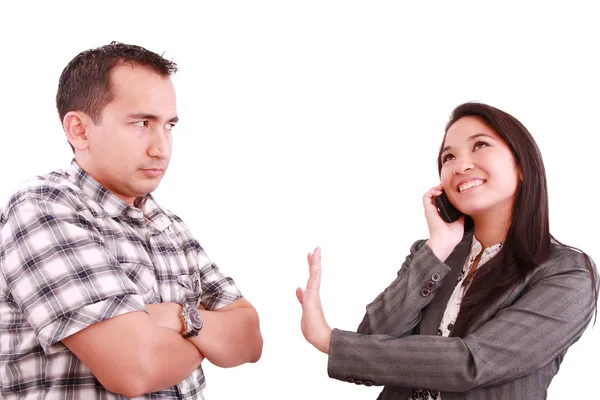 Mujer de negocios sonriente en el teléfono señalando a su pareja para mantener —  Fotos de Stock