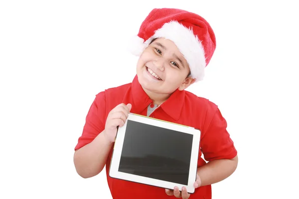 Criança adorável com chapéu de Papai Noel oferecendo um tablet isolado no whit — Fotografia de Stock