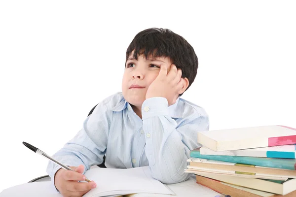 Écolier bouleversé faisant des devoirs isolés sur blanc — Photo