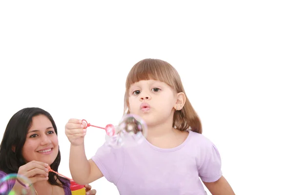Portrait of funny lovely little girl blowing soap bubbles with h — Stock Photo, Image