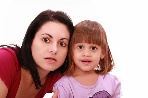 Mother and cute little daughter watch TV in great concentration — Stock Photo, Image