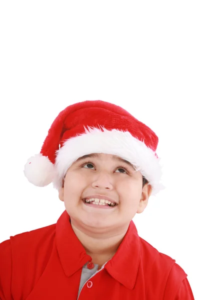 Menino bonito em chapéu de Papai Noel, olhando para cima para copiar espaço — Fotografia de Stock