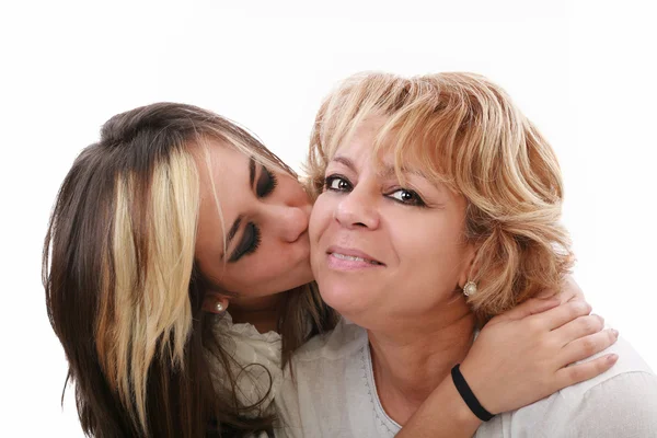 Closeup of young girl kissing her mom isolated on a white backgr — Stock Photo, Image