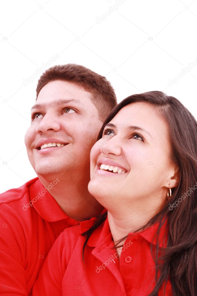 Young loving couple looking up to the sky, standing over white,