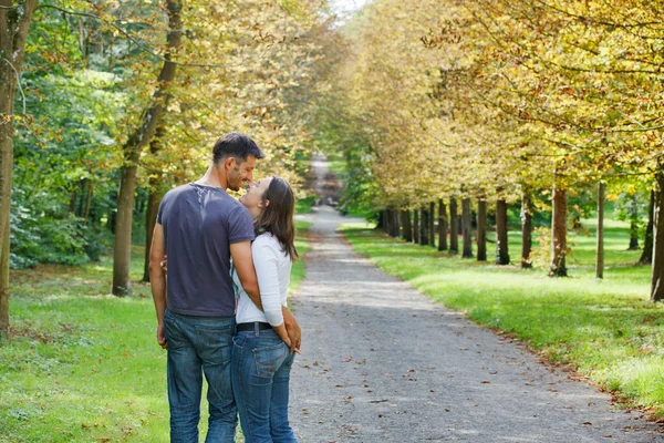 Young Couple Walking in autumn park — Stock Photo, Image