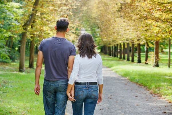 Jovem casal andando no parque de outono — Fotografia de Stock