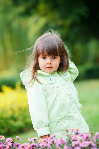 Little girl in red making funny face. — Stock Photo, Image