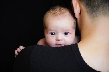 Father holding newborn baby clipart