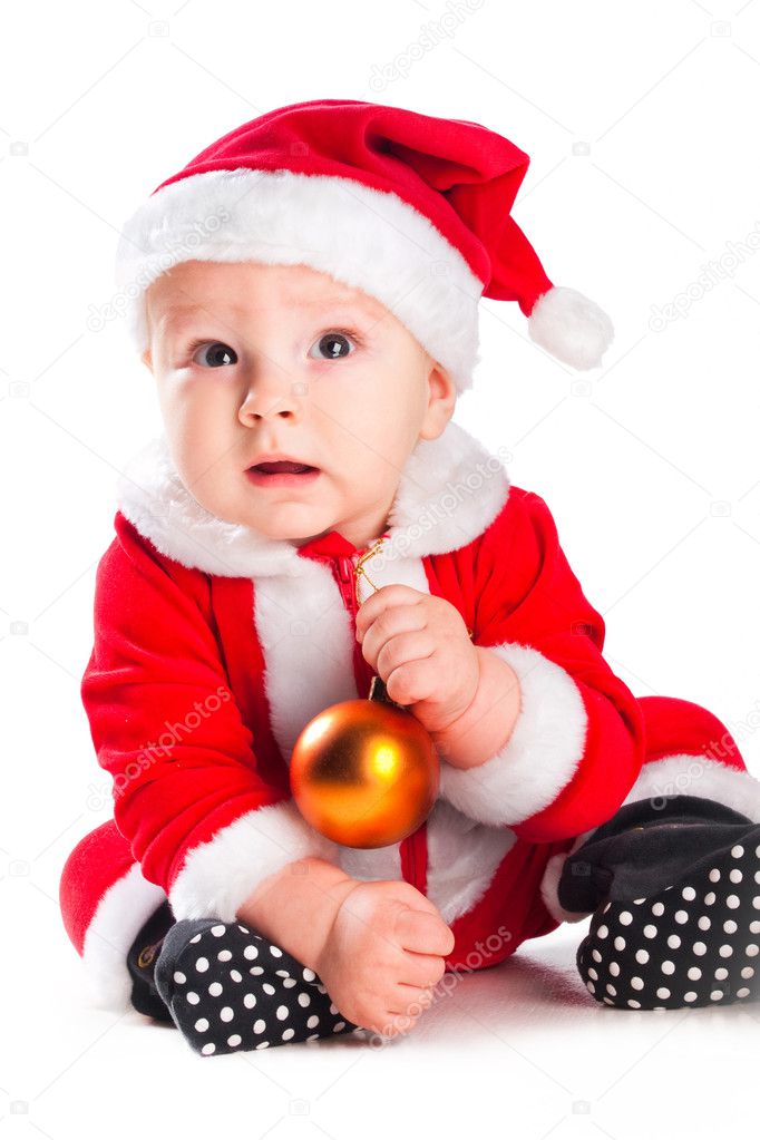 Little cute baby gnome in red with golden ball