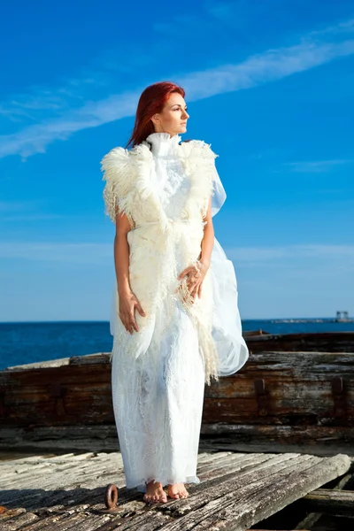 stock image Beautiful woman in white on seacoast