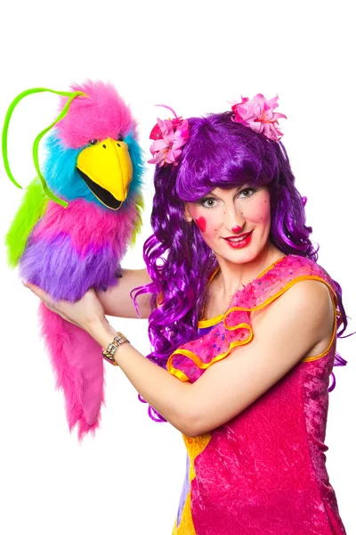 Female clown with colorful toy bird — Stock Photo, Image