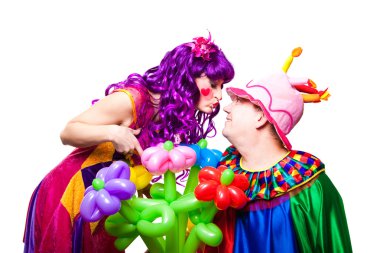 Loving clowns with colorful flowers