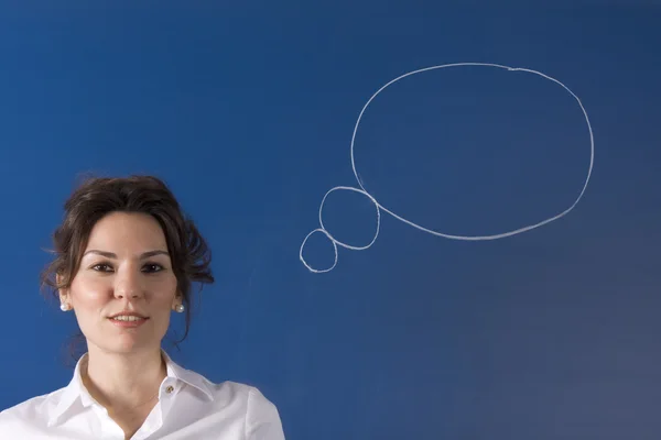 Thinking business woman in front of question marks — Stock Photo, Image