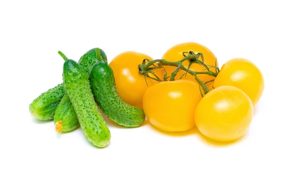 Yellow tomatoes and cucumbers on a white background — Stock Photo, Image