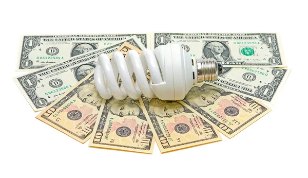Lampadina a risparmio energetico e banconote su sfondo bianco — Foto Stock
