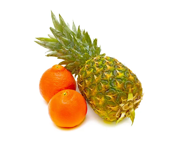 Pineapple and tangerines on a white background — Stok fotoğraf