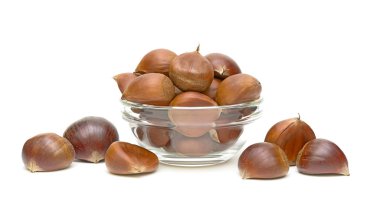 Chestnuts (Castanea sativa) in a glass bowl clipart