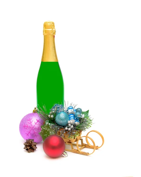 Christmas decorations and a bottle of champagne close up — Stock Photo, Image