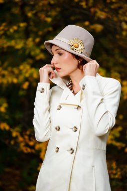 Attractive woman in evening autumn park