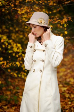 Attractive woman in evening autumn park