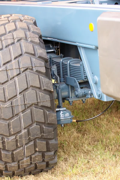 Shock absorber and tire of a large farm trailer