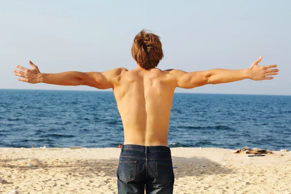 stock image Man's back on the beach, freedom, success