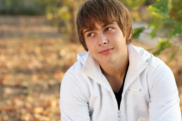 Portrait Of Young Man In Autumn Park, sunshine — Stock Photo, Image