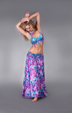 Sensual belly dancer in studio space clipart