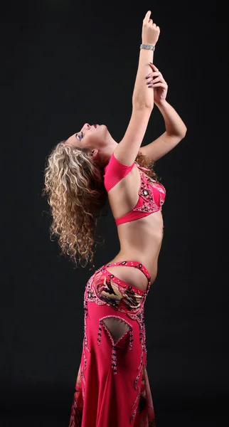 Beautiful exotic belly dancer woman posing on black background — Stock Photo, Image