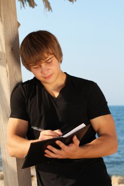 Young business man waiting for meeting, working with papers, out clipart