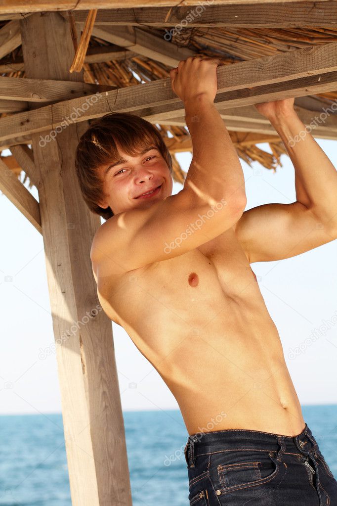Happy strong healthy young man on a beach