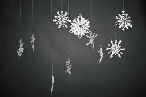 Dark gray background with paper snowflakes — Stock Photo, Image