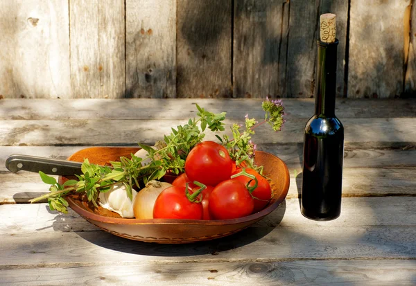 stock image Fresh vegetables and wine on wood.