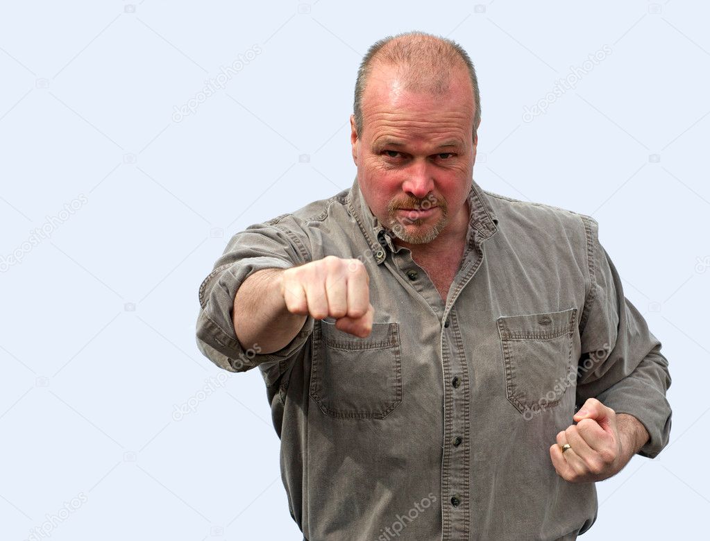 Angry man throwing a punch.