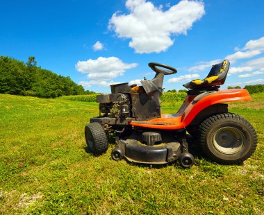 Wide angle old riding mower. clipart