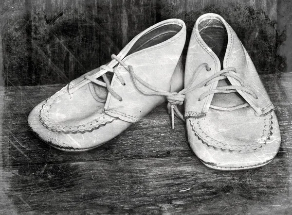 Vintage style image with desaturated baby shoes. — Stock Photo, Image
