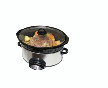 Slow cooker with roast beef and vegetables.
