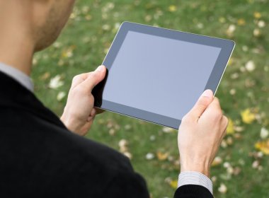 Businessman Holding A Tablet PC clipart