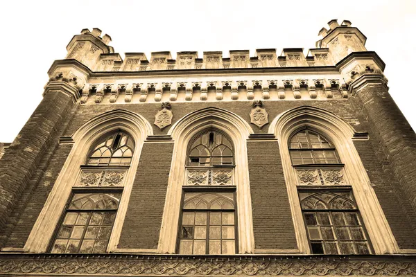 Old building in the Gothic Revival style. Sepia. — Stock Photo, Image