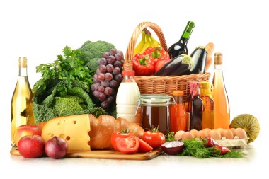 Groceries in wicker basket including vegetables and fruits